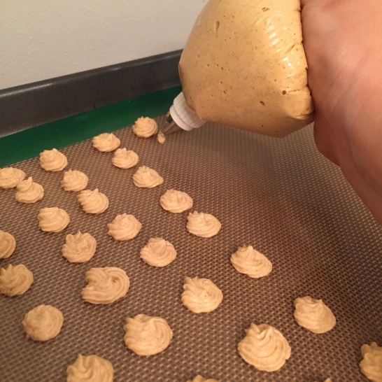place mixture into piping bag and pipe dime-sized treats onto lined baking sheet